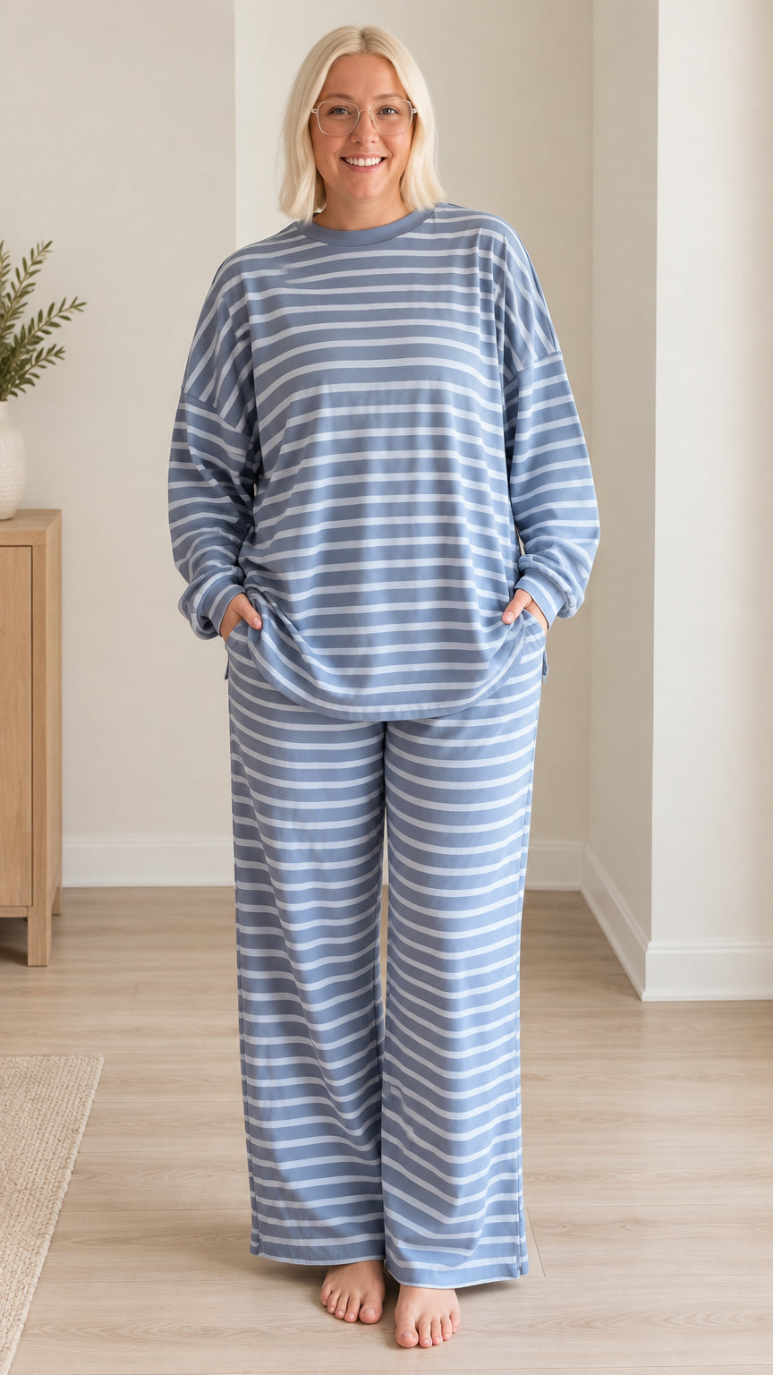 Front view of woman wearing blue striped long sleeve top and wide leg pajama pants set