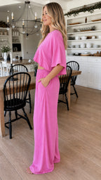 Side profile view of woman in fuchsia two piece lounge set