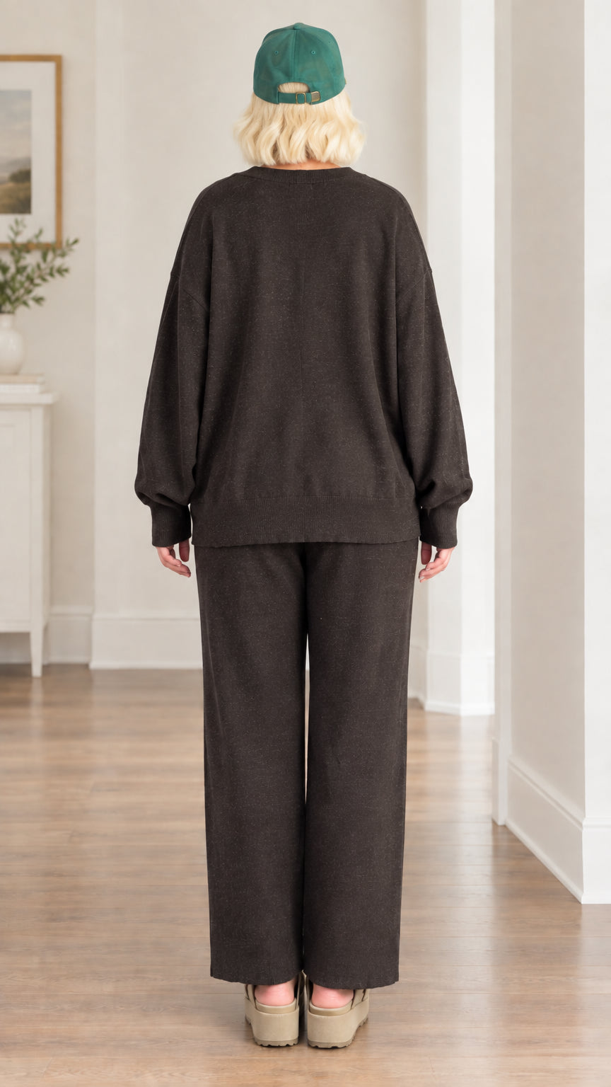 Back view of woman wearing relaxed-fit charcoal knit cardigan and wide-leg lounge pants