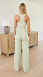 Back view of Sage Green jumpsuit showing racerback detail and wide pant leg