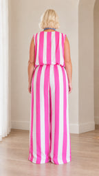 Back full view of woman wearing pink and white vertical striped matching set