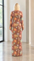 Back view of model wearing floor-length brown celestial printed long sleeve dress