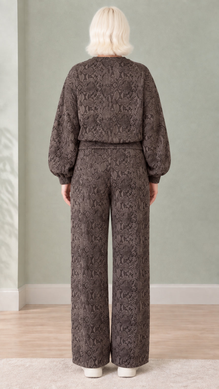Back view of woman wearing dark brown snakeskin print sweatshirt and matching pants