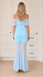 Back view of woman wearing off-the-shoulder ruched maxi dress in sky blue
