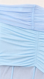 Close-up detail of sky blue gathered stretch mesh fabric and ruched seam