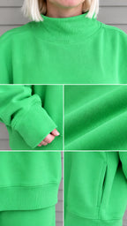 Close-up details of green sweatshirt collar, ribbed cuffs, knit fabric texture, and jogger side pocket