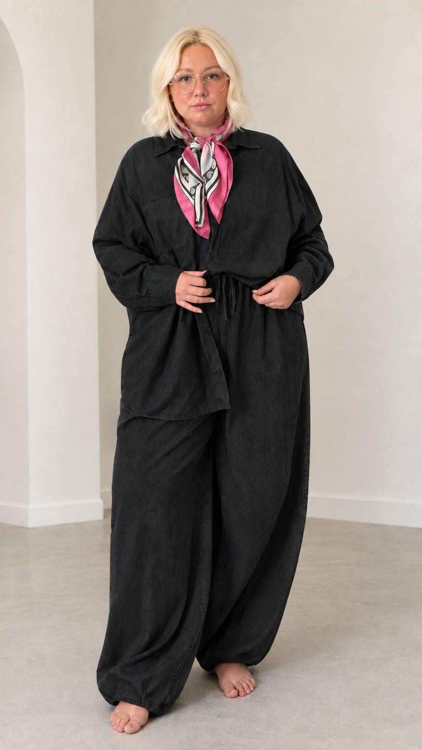 Front full-length view of model wearing Black button-down shirt and matching wide-leg pants set