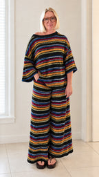 Front full view of woman wearing black multicolor striped knit top and pants set