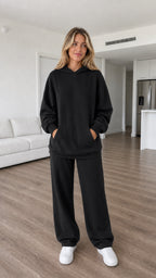Model wearing black oversized hoodie and wide-leg sweatpants set