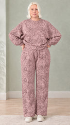 Woman wearing dusty rose snakeskin print sweatshirt and wide-leg pants set