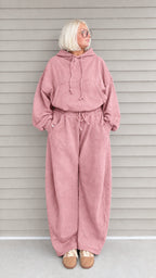 Front view of woman wearing dusty pink oversized hoodie and wide-leg sweatpants lounge set