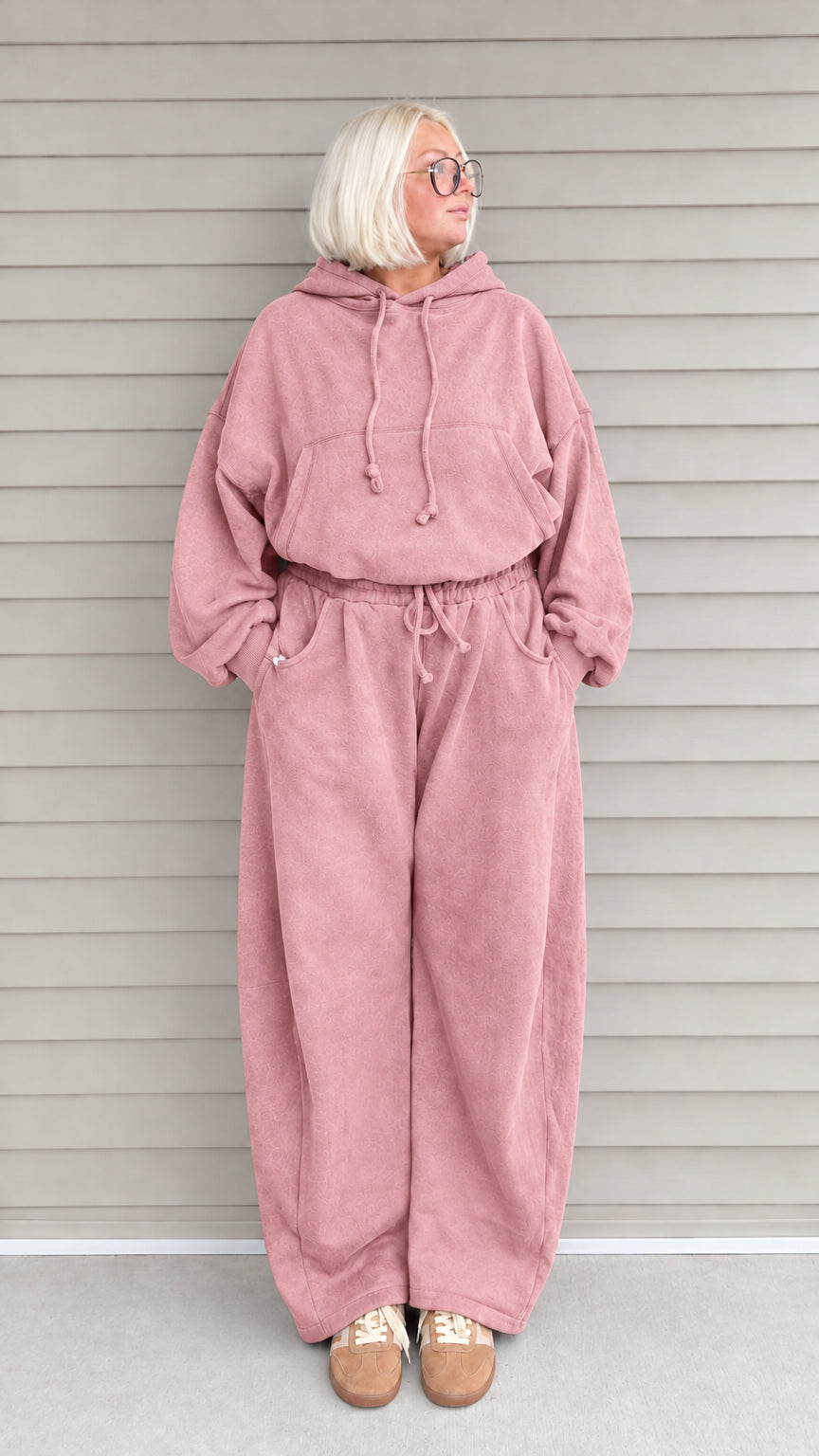 Front view of woman wearing dusty pink oversized hoodie and wide-leg sweatpants lounge set