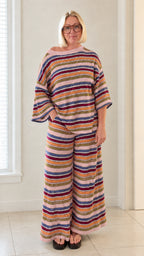 Front full view of woman wearing pink multicolor striped knit two piece set