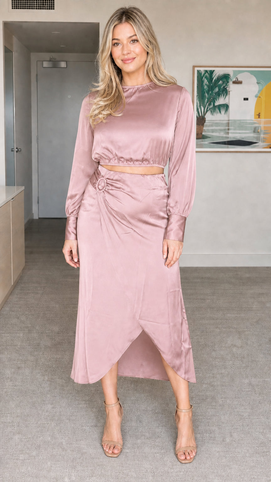 Model wearing dusty rose satin long sleeve crop top and midi skirt set