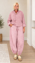 Model wearing dusty pink washed denim matching top and pant set