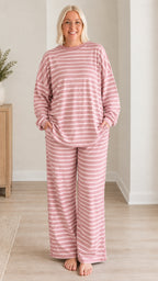 Front view of woman wearing dusty pink striped long sleeve lounge set