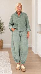 Model wearing sage green washed denim shirt and balloon pants set