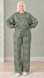Woman wearing sage green snakeskin print sweatshirt and wide-leg pants set