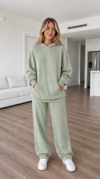 Model wearing sage green oversized hoodie and sweatpants set