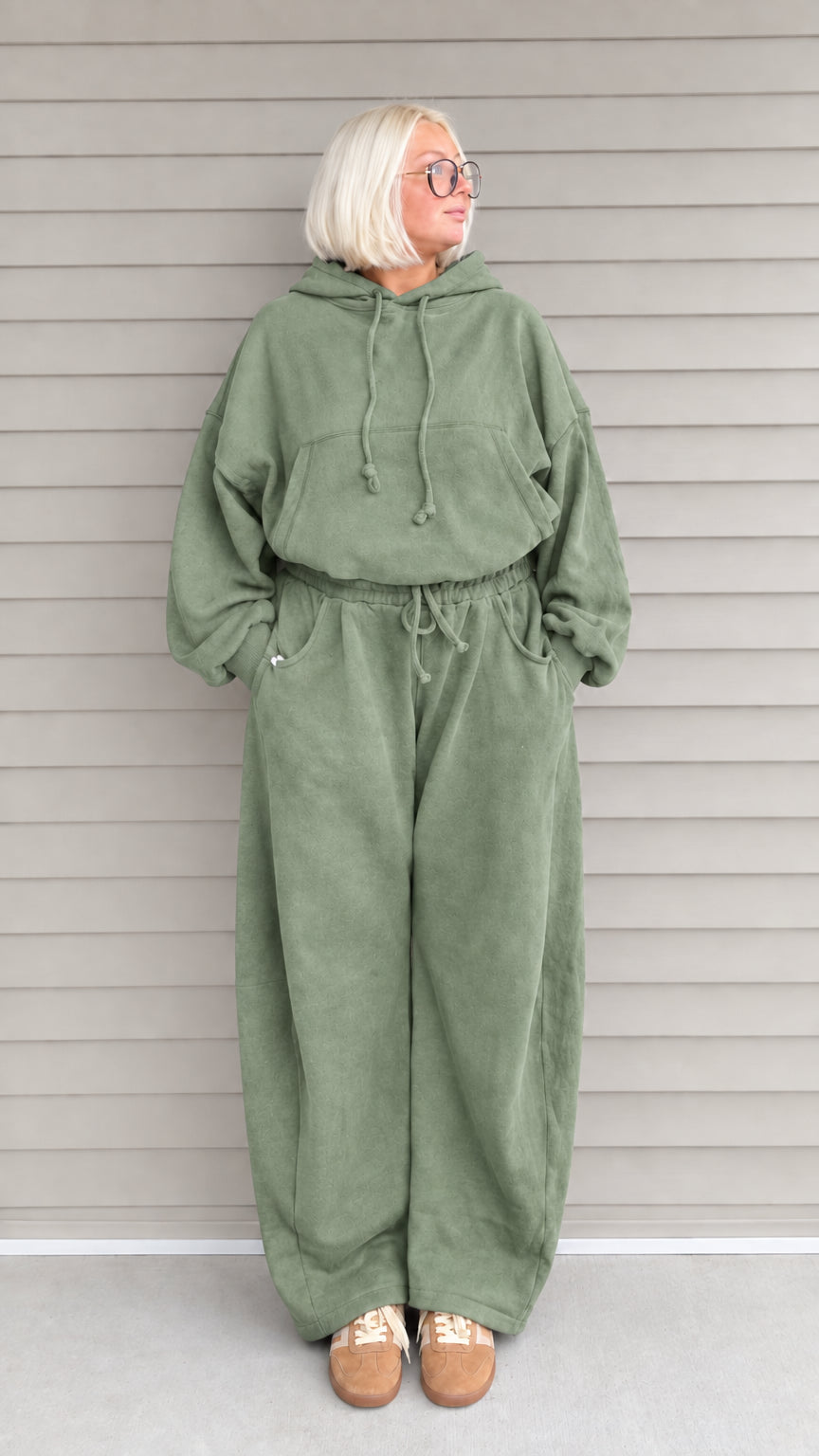 Front view of woman wearing sage green oversized hoodie and wide-leg sweatpants lounge set