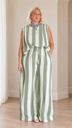 Full front view of woman wearing sage green and white striped two-piece pants set