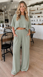 Front view of woman wearing sage green two piece cropped top and wide leg pant set