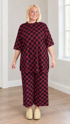 Burgundy and black checkered two-piece tunic and wide-leg crop pants set