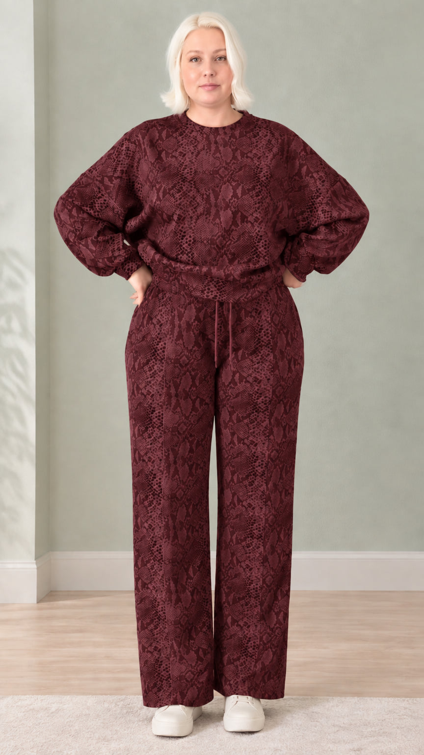 Woman wearing burgundy wine red snakeskin print sweatshirt and wide-leg pants set