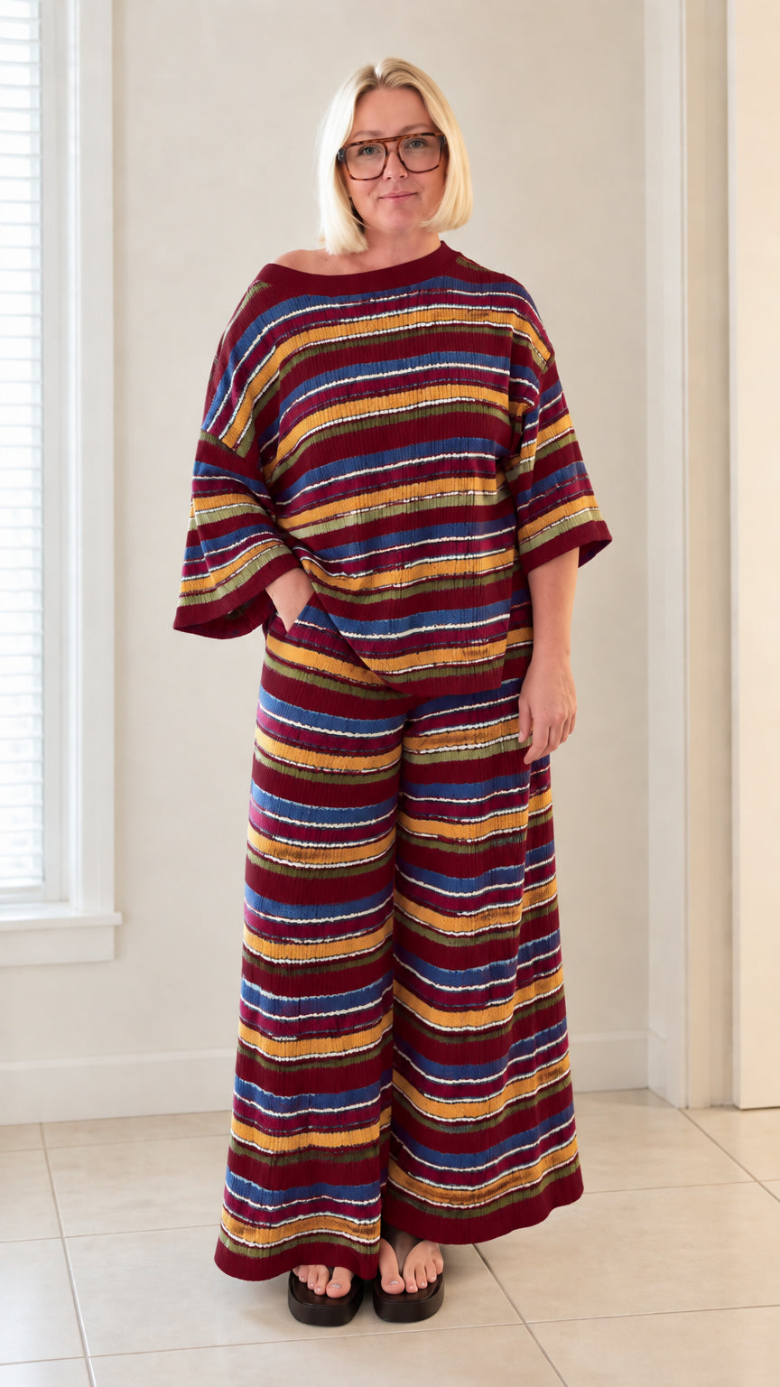 Front full view of woman wearing burgundy red multicolor striped knit two piece set