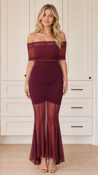 Front view of woman wearing off-the-shoulder ruched mesh mermaid dress in burgundy