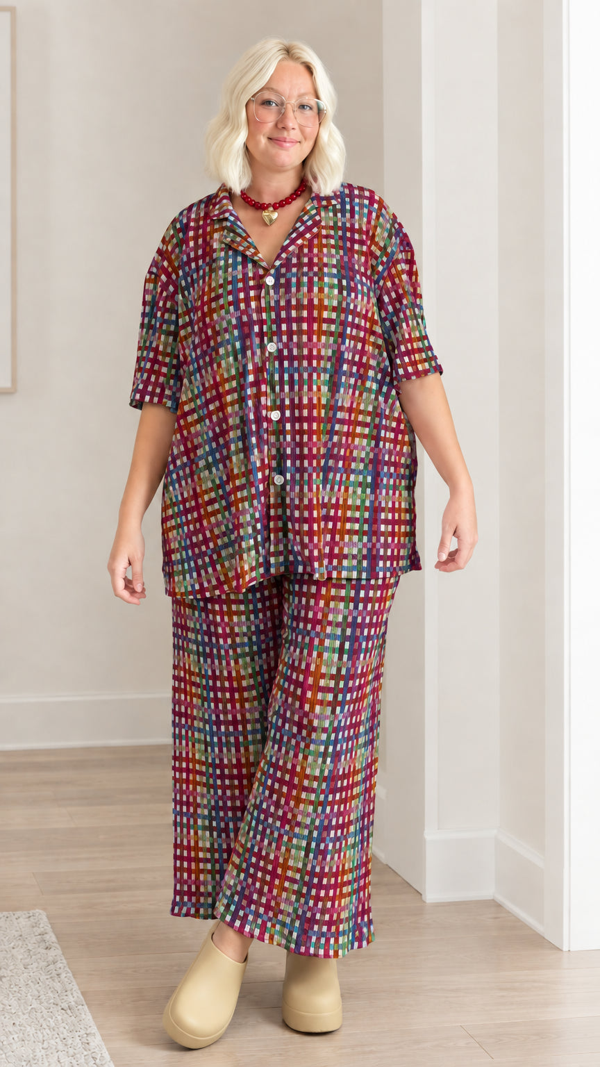 Model wearing burgundy multicolor plaid textured shirt and matching pants set