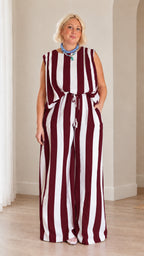 Full front view of woman wearing burgundy and white striped matching top and wide leg pants set