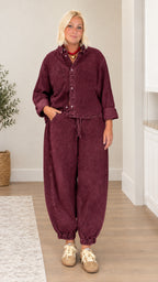 Model wearing burgundy washed denim button-up shirt and jogger pant set