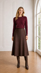 Model wearing burgundy wine long sleeve crewneck sweater with brown skirt