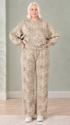 Woman wearing beige taupe snakeskin print sweatshirt and wide-leg pants set