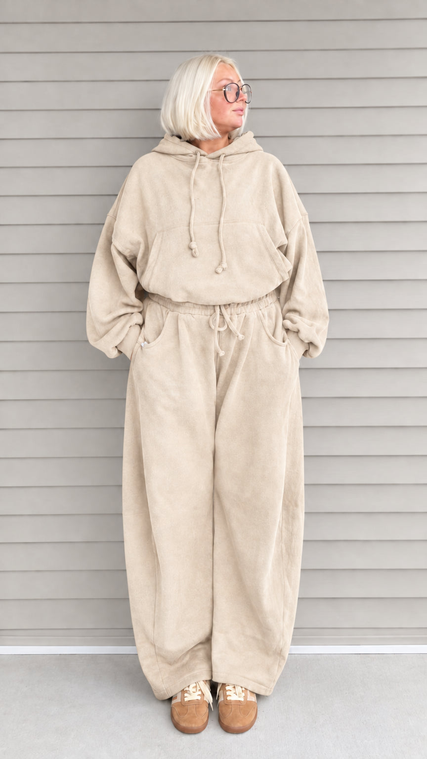 Front view of woman wearing beige oversized hoodie and wide-leg sweatpants lounge set