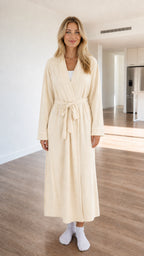 Front view of model wearing cream white long knit robe with contrast piping