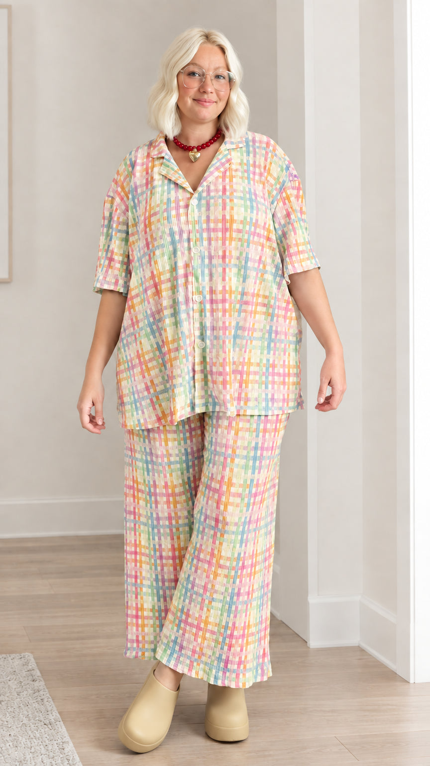 Model wearing peach and yellow multicolor plaid plissé short sleeve two-piece set