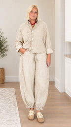 Model wearing khaki beige washed denim matching shirt and pants set