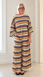 Front view of woman wearing cream multicolor striped knit wide leg two piece set