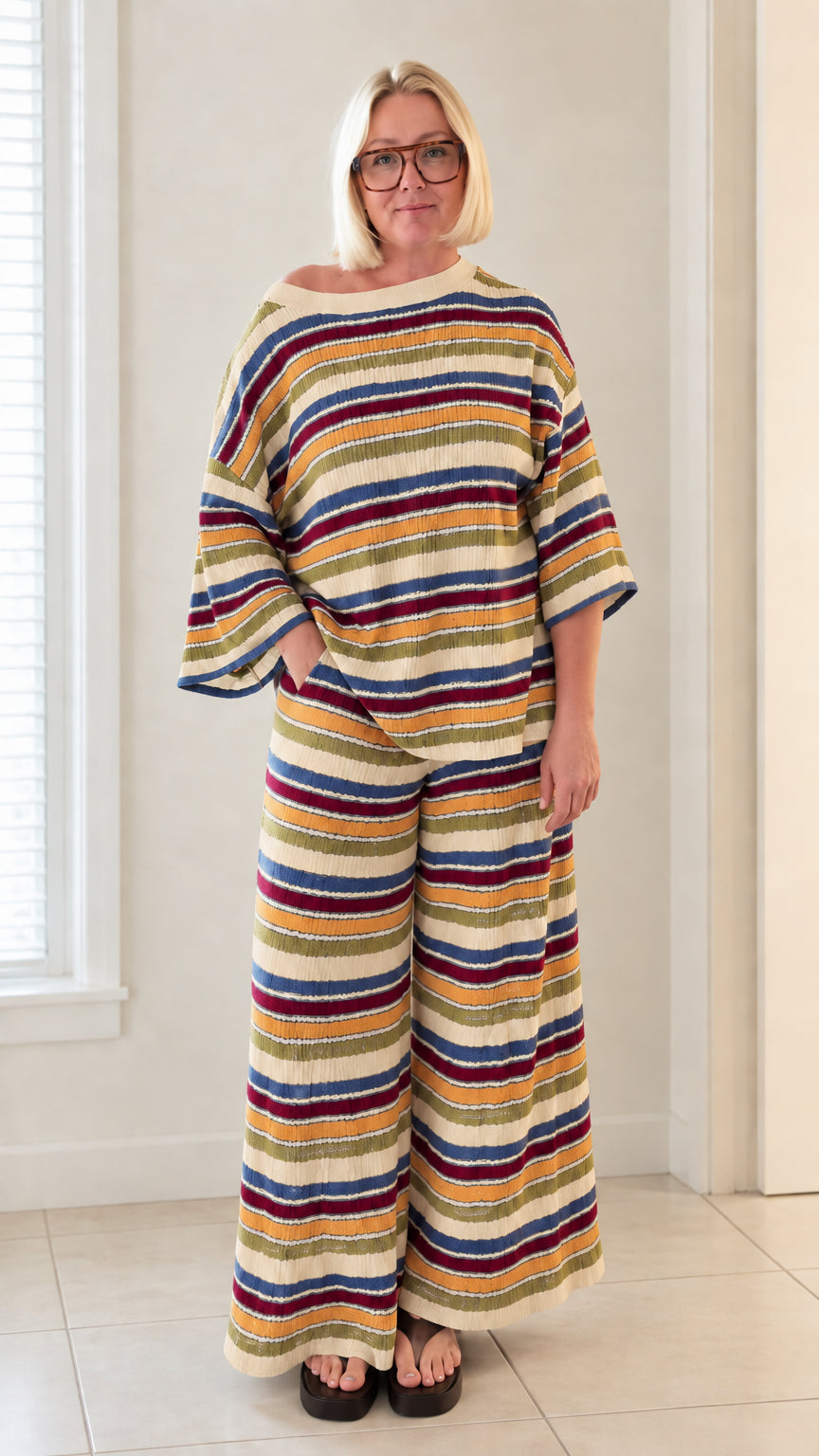 Front view of woman wearing cream multicolor striped knit wide leg two piece set